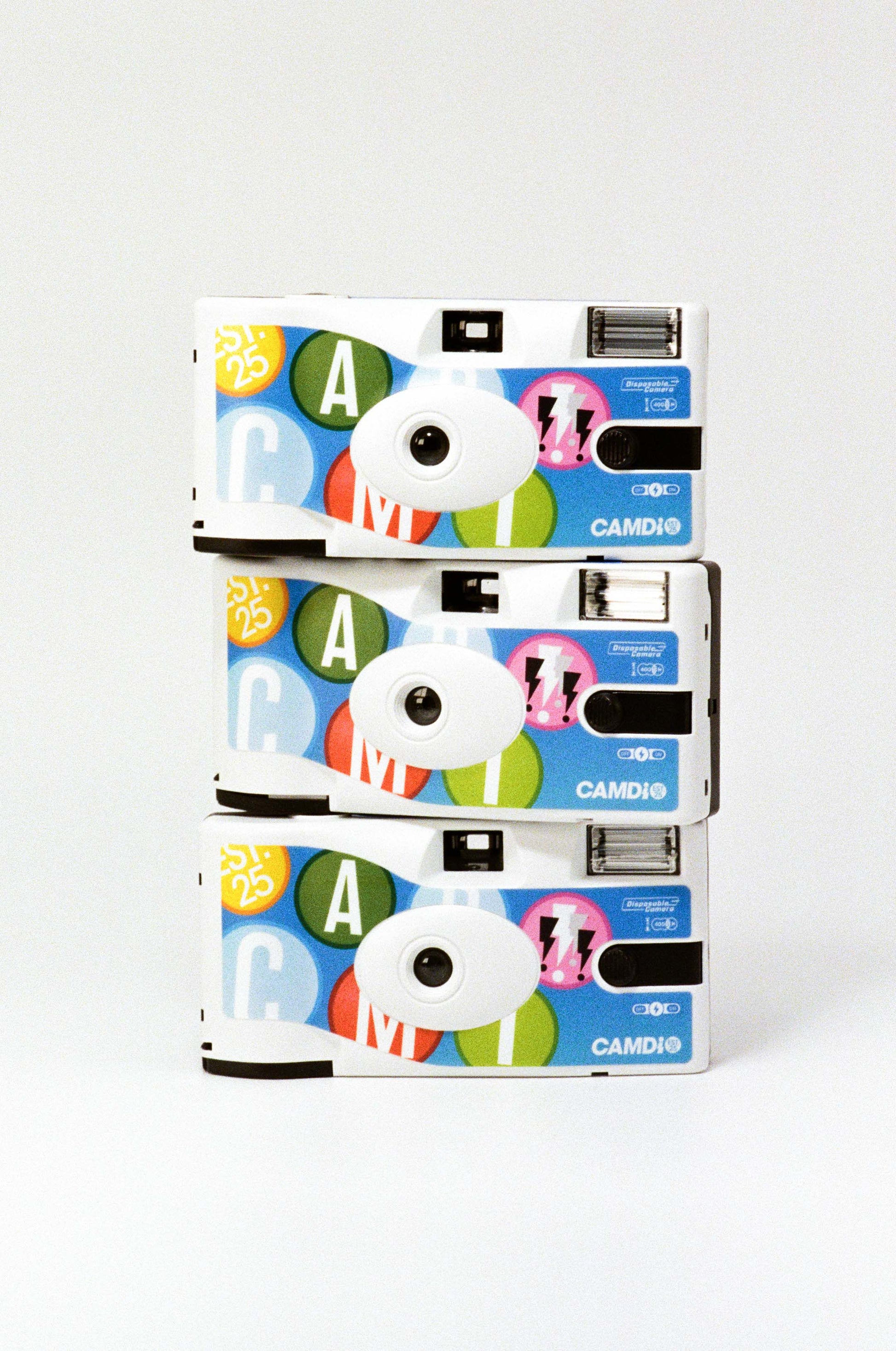 Three colorful camera stacked on a white background